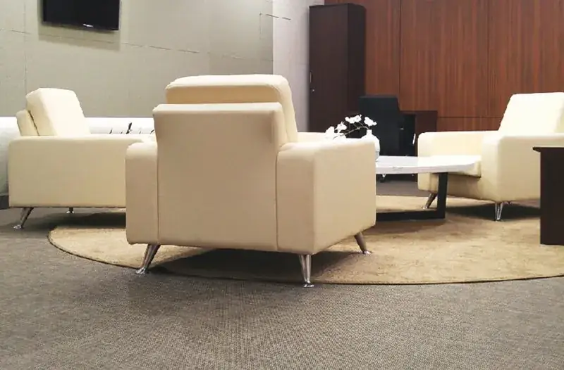 Lounge seating in a hotel in woven vinyl upholstery and wall to wall flooring