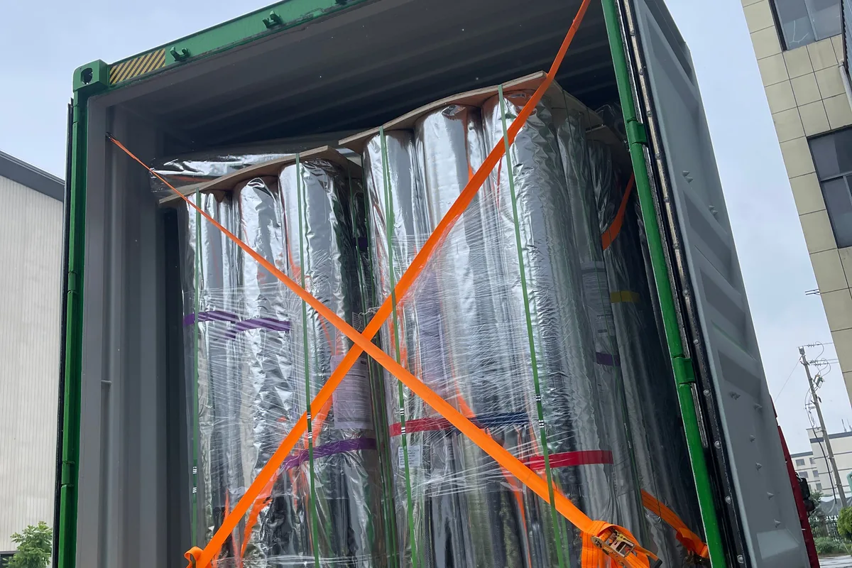 Wall to wall rolls on pallets, strapped and loaded into the container at the woven vinyl production base in Zhejiang
