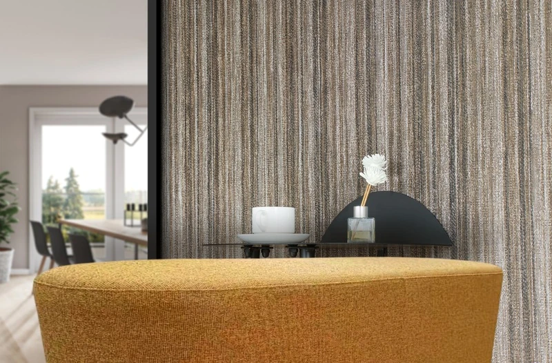 Close-up of texlyweave woven vinyl upholstery fabric on a feature wall behind an upholstered bench in the same weave, furniture and wall upholstery in one space